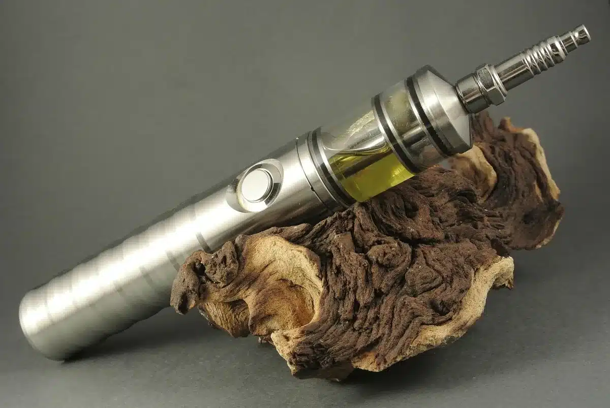 Comptoir clair d'une boutique de vape, mains anonymes tenant un flacon d'e-liquide